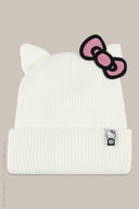 White ribbed knit beanie with cat ears, pink Hello Kitty bow patch, and branded label