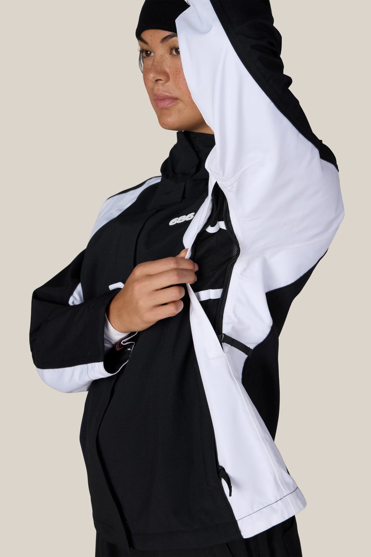 Women's shell jacket in two-tone colorblock design with hood, shown open on model