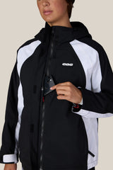 686 women's shell jacket with hood, chest pocket, and zip closure shown on model