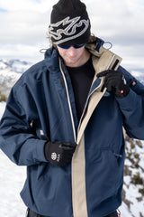 Men's ski jacket with zip opening shown in outdoor snowy mountain setting on model