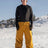 Men's insulated ski pants in a relaxed fit, worn on a snowy mountain slope
