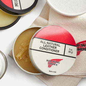 Red Wing Shoes all natural leather conditioner tin on cloth, open container showing balm