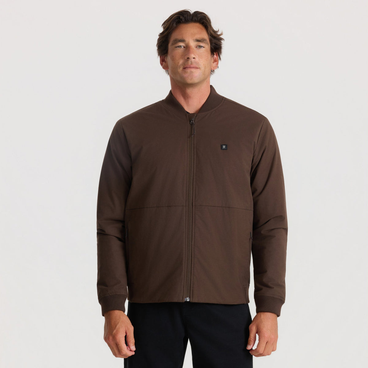 Men's zip-up bomber jacket with ribbed cuffs and small logo patch on chest