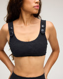 Black textured swirl pattern bikini top with decorative buttons on wide straps