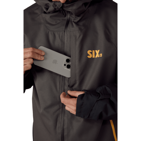 686 Six Crust men's hooded jacket with chest pocket shown storing a smartphone