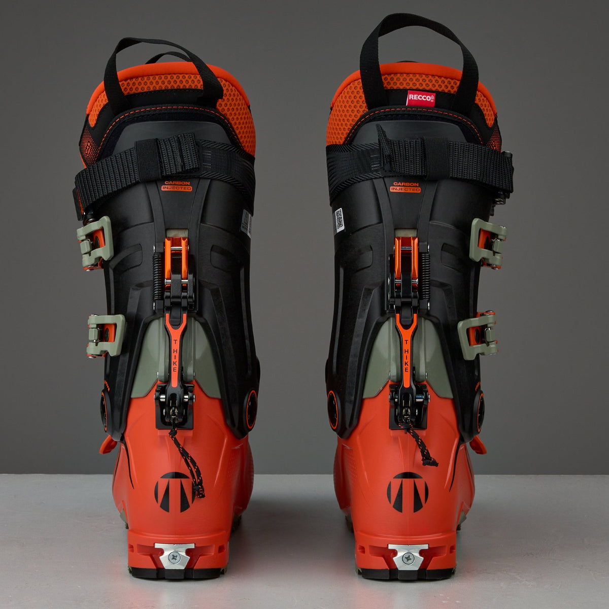 Rear view of a pair of alpine touring ski boots with buckle closure system and RECCO reflector