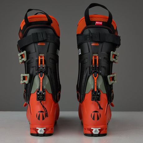 Rear view of a pair of alpine touring ski boots with buckle closure system and RECCO reflector