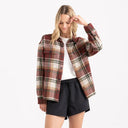 Women's oversized red plaid flannel shacket with chest pockets and snap buttons