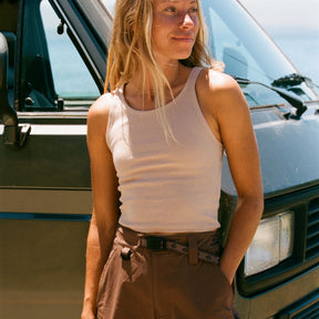 Roark Wind Worn ribbed white tank top worn with brown belted pants outdoors