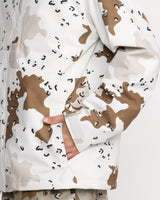 Close-up of a men's double insulated jacket featuring a desert camouflage pattern with pocket detail