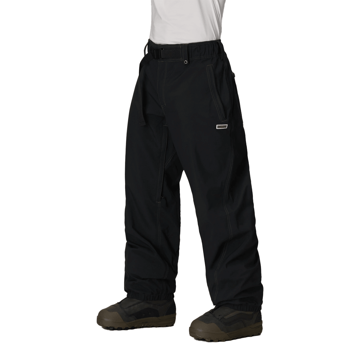 Men's baggy snow pants with belt, contrast stitching, and snowboard boot-compatible hem.