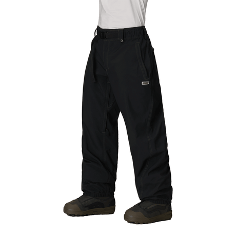 Men's baggy snow pants with belt, contrast stitching, and snowboard boot-compatible hem.