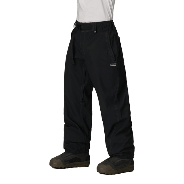 Men's baggy snow pants with belt, contrast stitching, and snowboard boot-compatible hem.