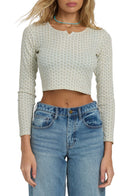 Billabong cream floral print long sleeve crop top paired with wide-leg blue jeans