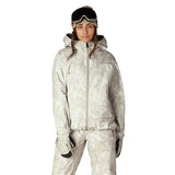 Women's hooded ski jacket with matching pants, gloves, and snow goggles on model
