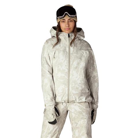 Women's hooded ski jacket with matching pants, gloves, and snow goggles on model