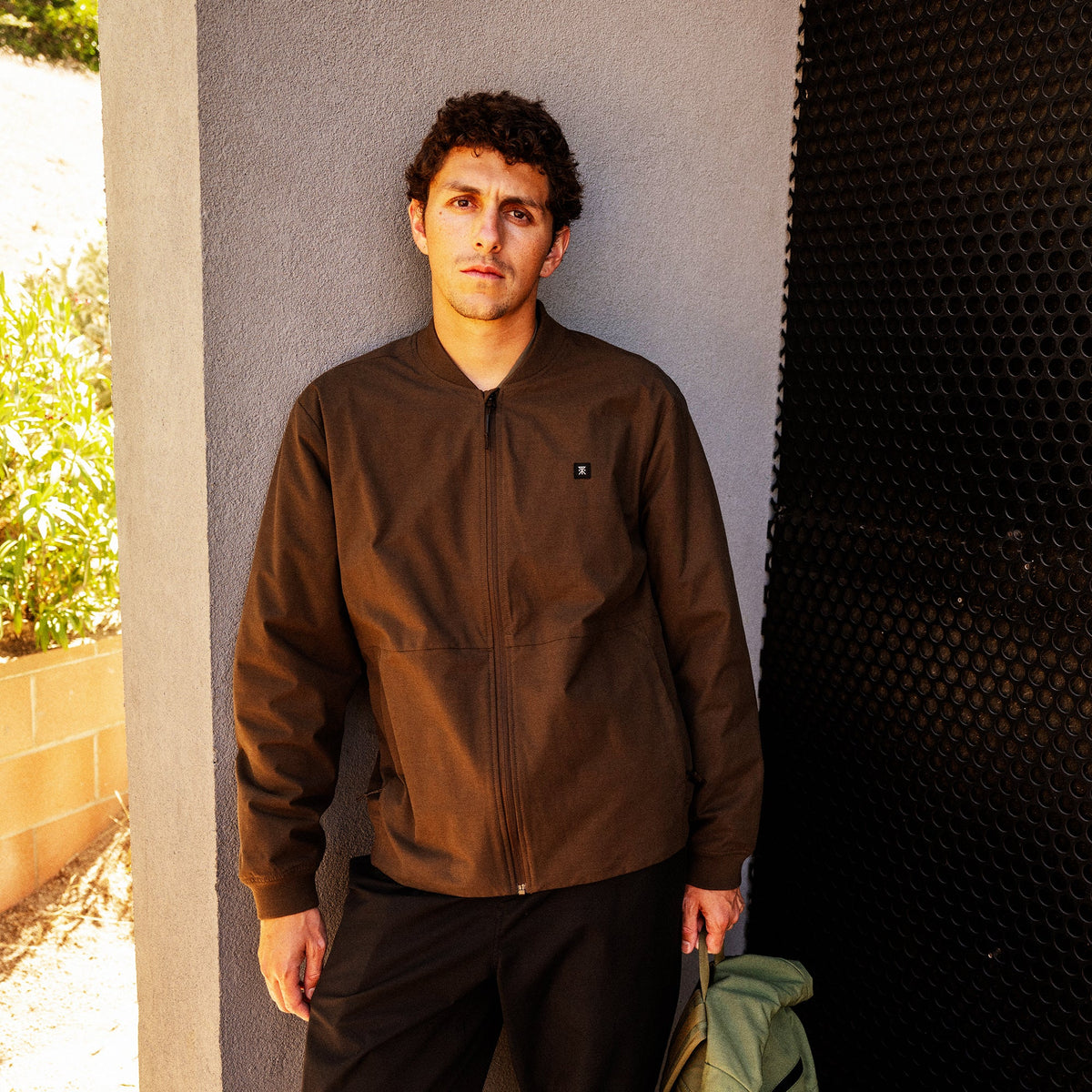 Men's zip-up bomber jacket with ribbed cuffs and small chest logo patch