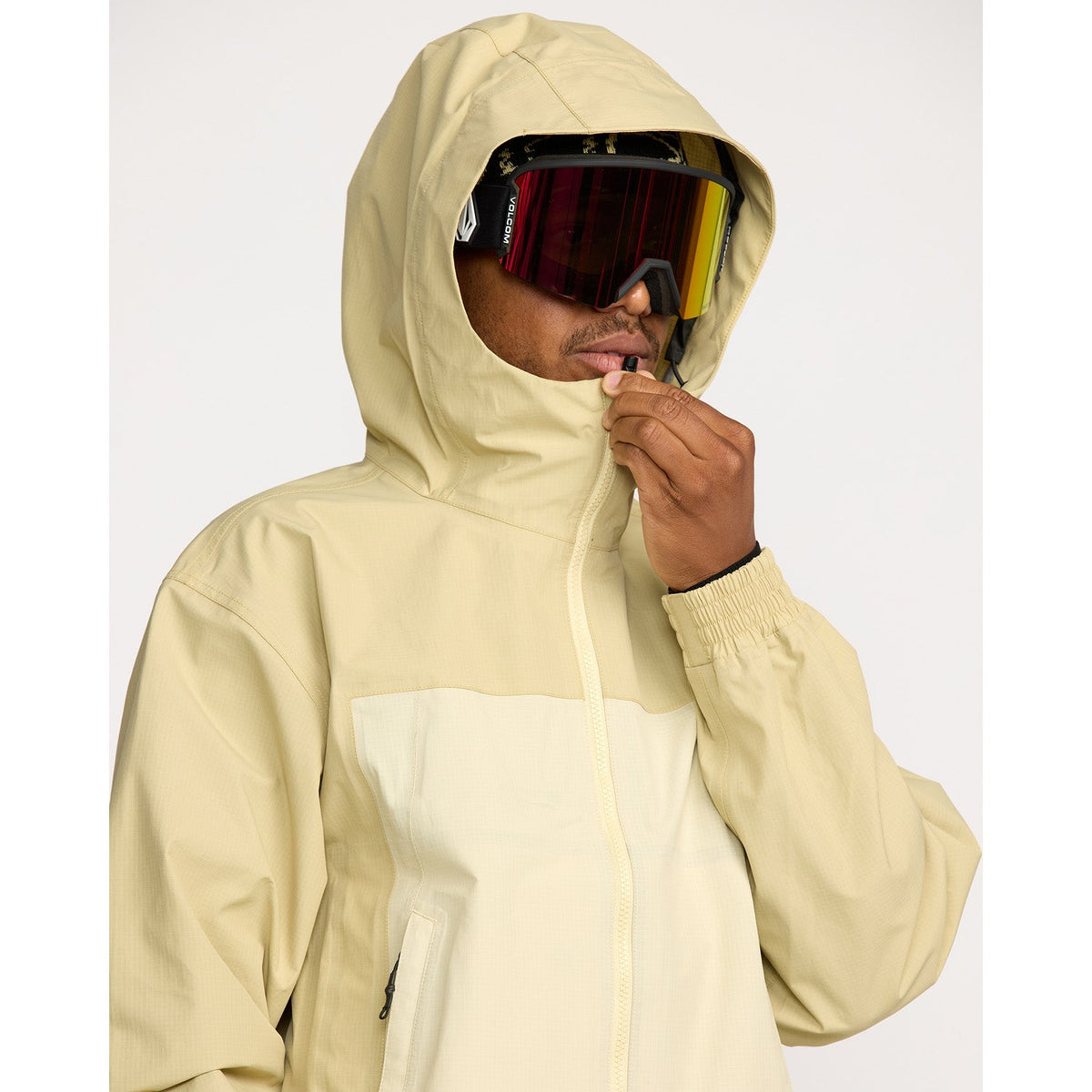 Volcom men's hooded snow jacket with red ski goggles and zip closure detail