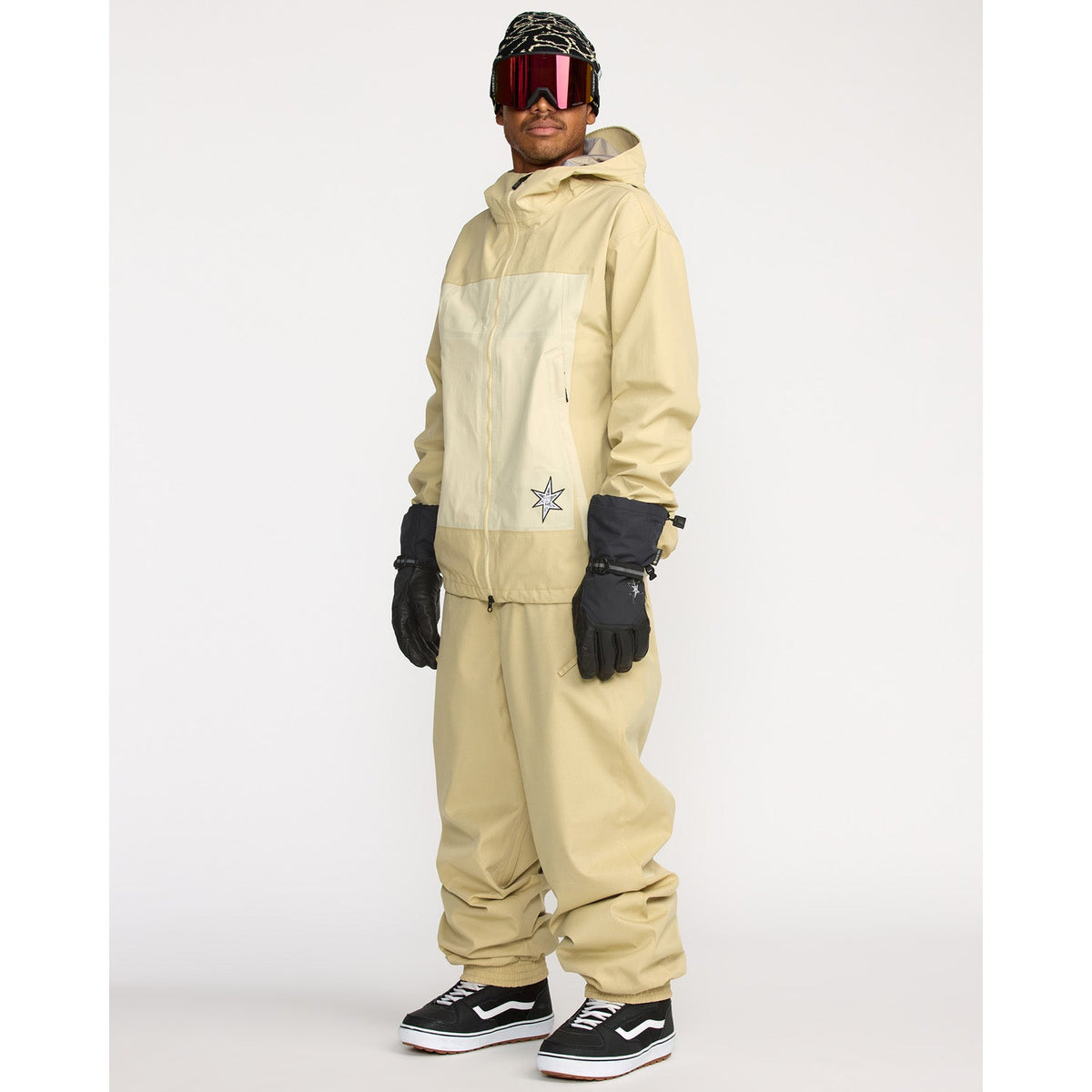 Men's technical snowboard jacket with hood, worn with matching pants and ski goggles