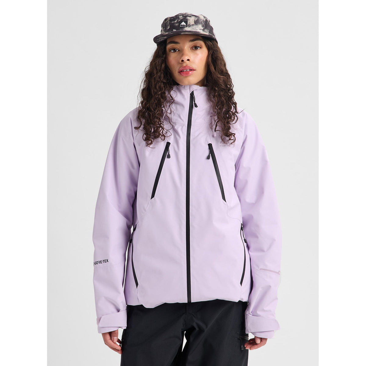 Women's Burton insulated Gore-Tex ski jacket with black zipper accents and hood, worn by model
