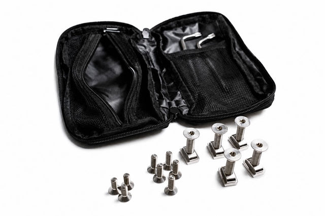 Black zip case open beside titanium bolts, T-nuts, and tools for hydrofoil setup